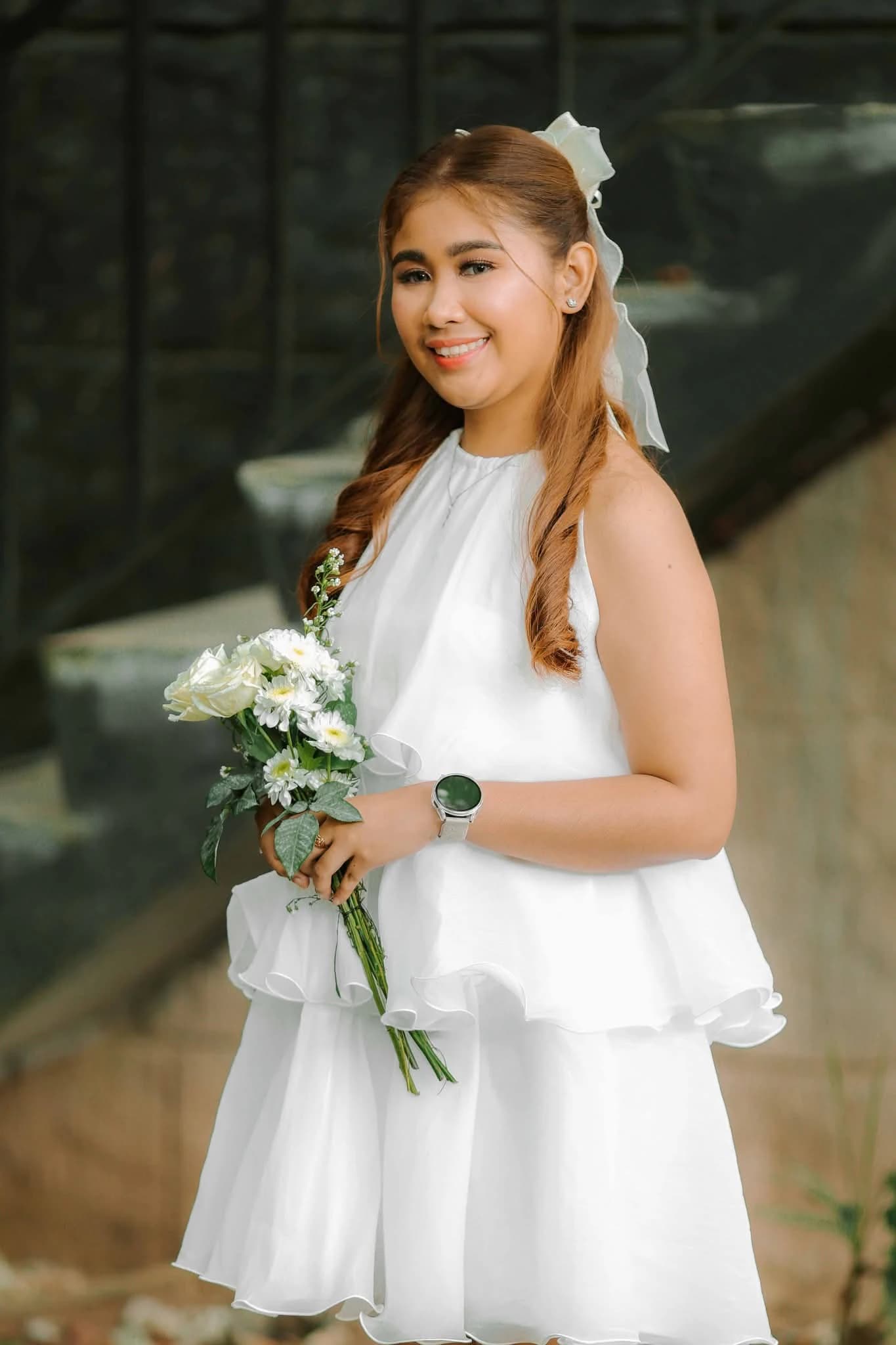 Civil bride in a modern white peplum dress holding a bouquet