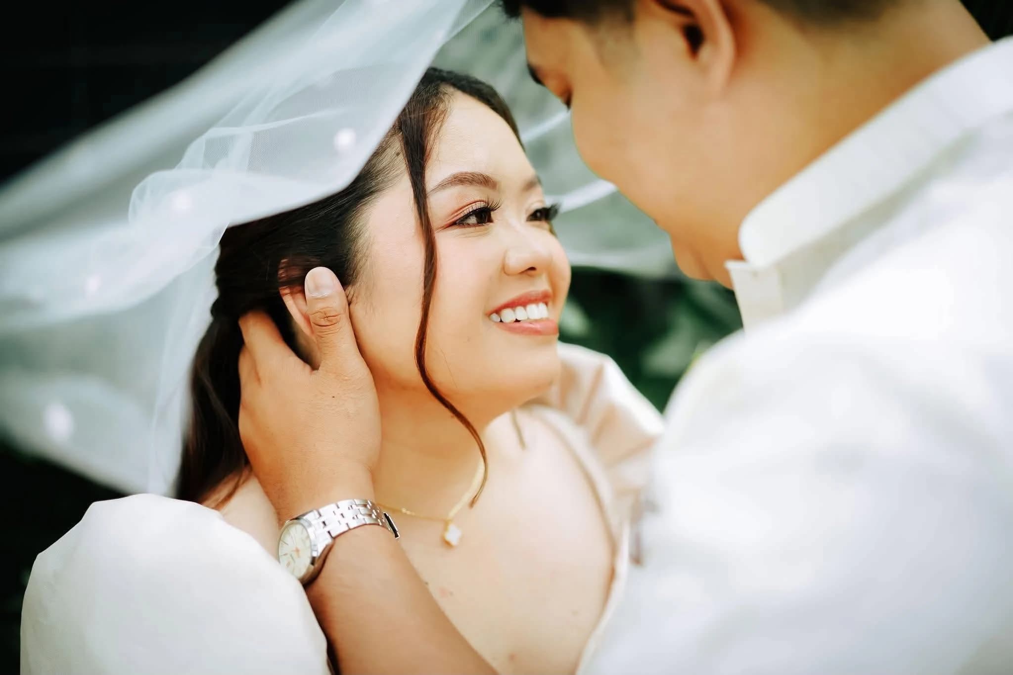 Civil wedding couple sharing an intimate moment beneath the bride's veil