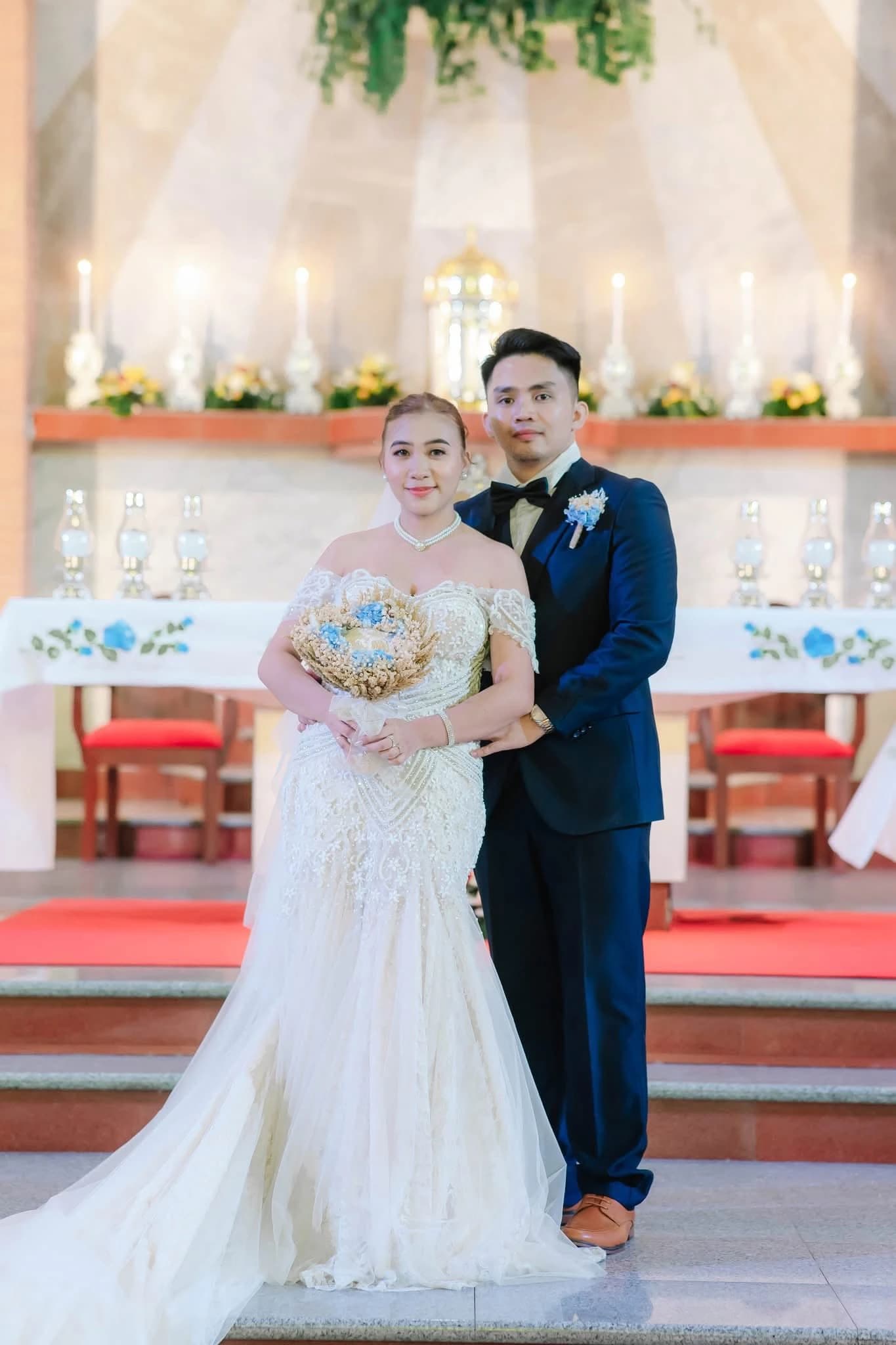 Bride and groom in a full-length church wedding portrait