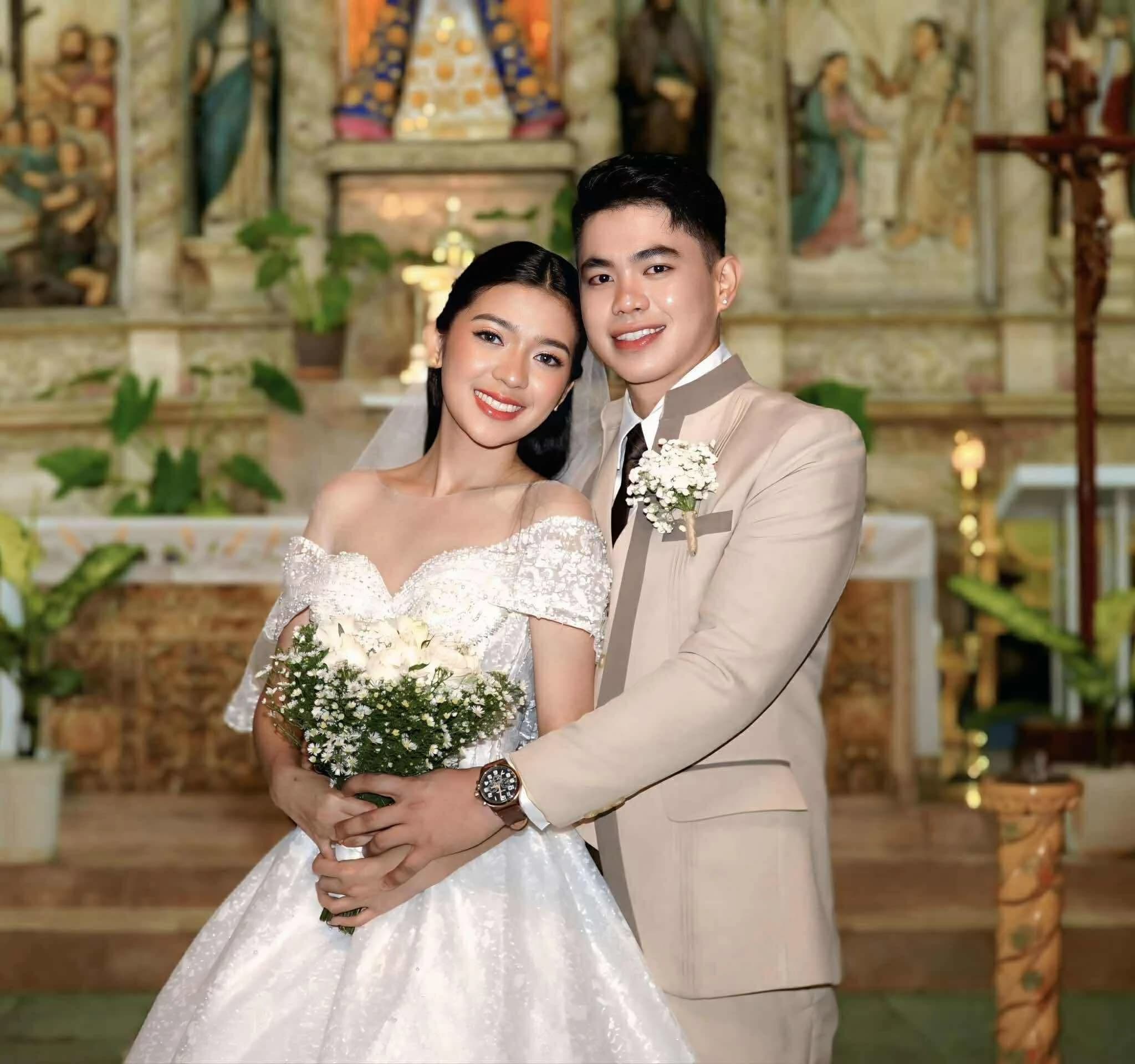 Newlywed couple smiling inside a church