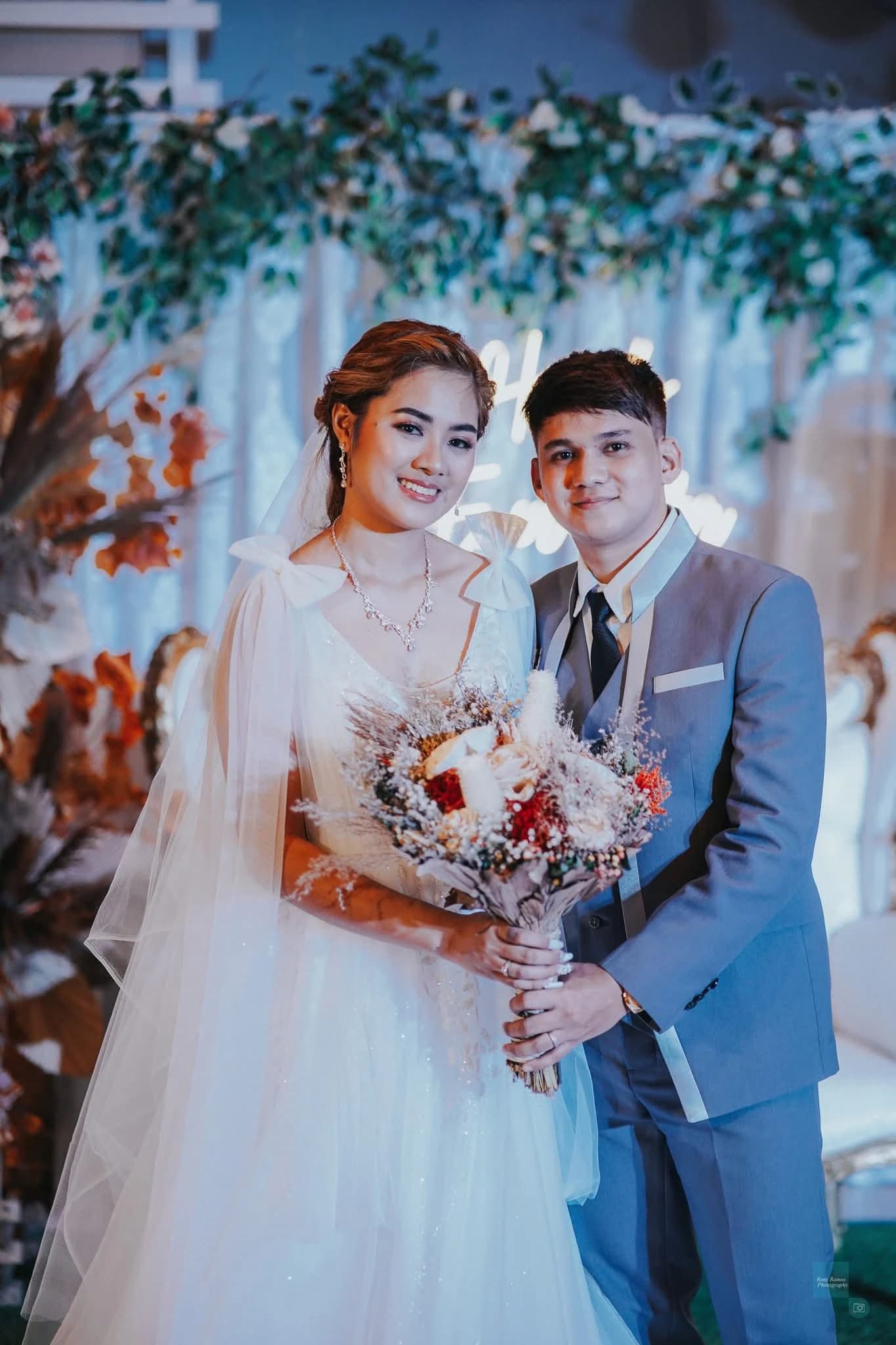 Bride and groom posing together at their wedding reception