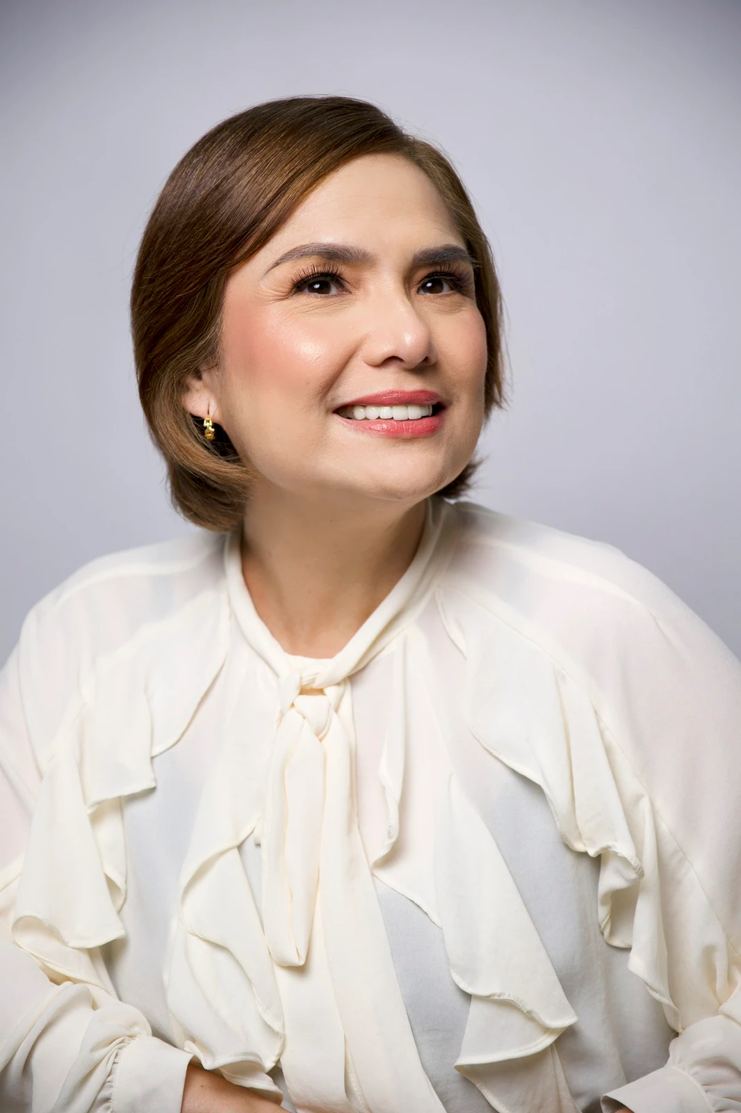 Mature client with luminous makeup and softly styled hair